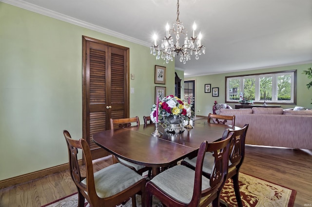 4231 N Conner Dr, Marion, IN 46952 - dining room featuring crown molding, baseboards, wood finished floors, and a notable chandelier
