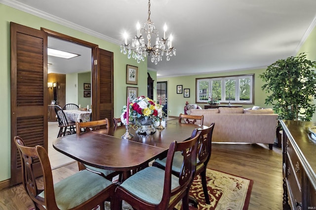 4231 N Conner Dr, Marion, IN 46952 - dining room with crown molding, a notable chandelier, and wood finished floors