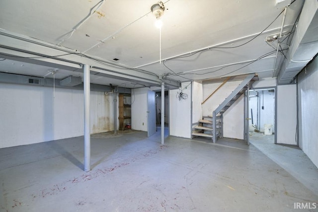 unfinished basement featuring stairway