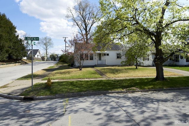 view of front of house with a front yard and concrete driveway