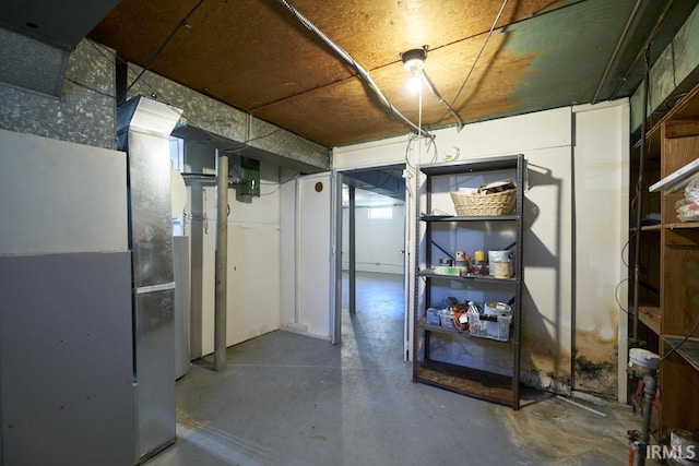 unfinished below grade area featuring heating unit