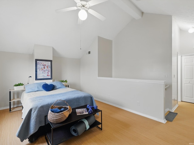 bedroom featuring a ceiling fan, baseboards, vaulted ceiling with beams, wood finished floors, and visible vents