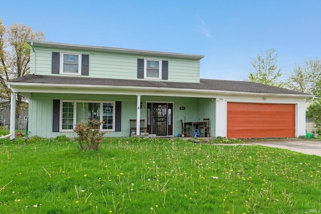 traditional-style house with a garage, a front yard, covered porch, and driveway