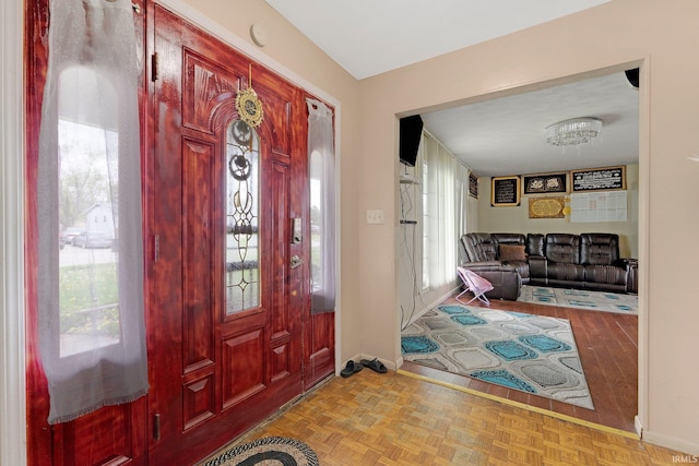 entrance foyer featuring plenty of natural light and baseboards