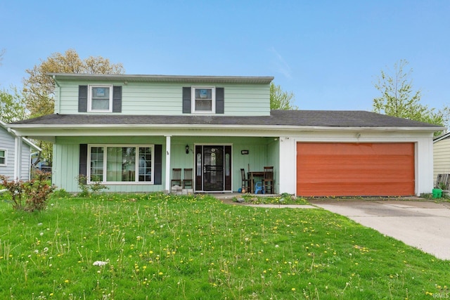 traditional-style house featuring a porch, an attached garage, driveway, and a front lawn