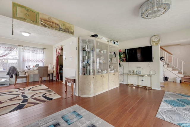 living room featuring stairway and wood-type flooring