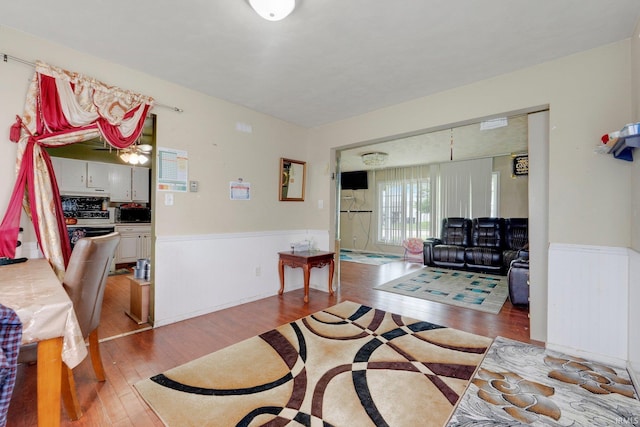 living room featuring wainscoting and wood finished floors