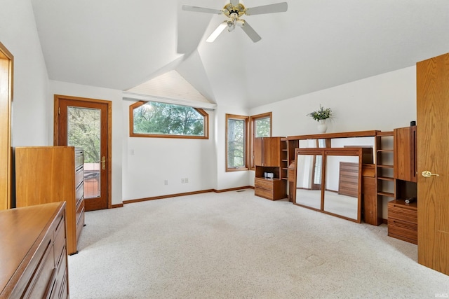 unfurnished bedroom featuring ceiling fan, light colored carpet, access to exterior, vaulted ceiling, and baseboards