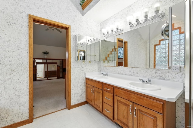 full bath featuring double vanity, a sink, a ceiling fan, and tile patterned flooring