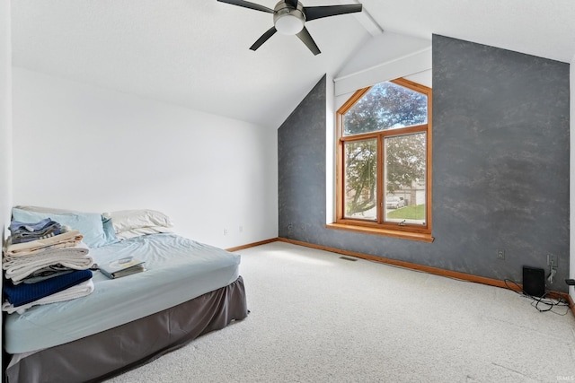 bedroom featuring carpet flooring, a ceiling fan, baseboards, and lofted ceiling with beams