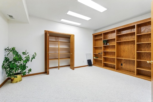 interior space featuring visible vents, carpet flooring, and baseboards