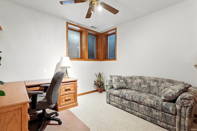 office featuring a ceiling fan, baseboards, visible vents, and carpet