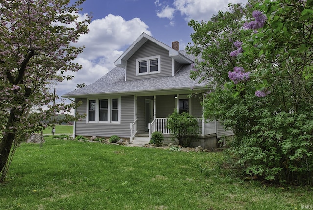 2165 S 625 W, South Whitley, IN 46787 - bungalow-style home featuring a shingled roof, a chimney, a porch, and a front yard