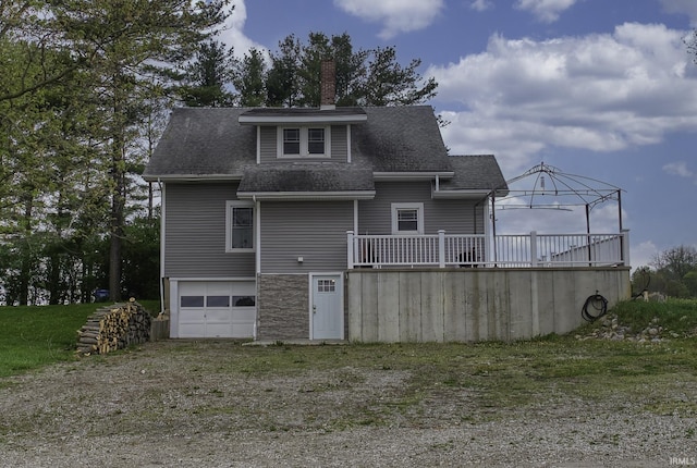2165 S 625 W, South Whitley, IN 46787 - back of property with driveway, a chimney, a wooden deck, an attached garage, and a shingled roof