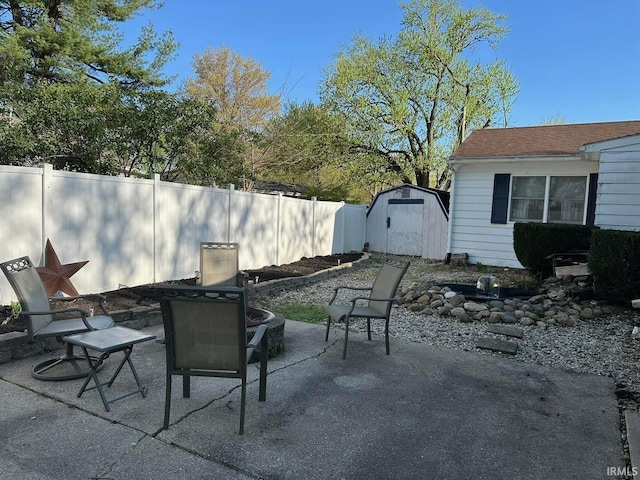 view of patio / terrace with an outdoor structure, a shed, and fence