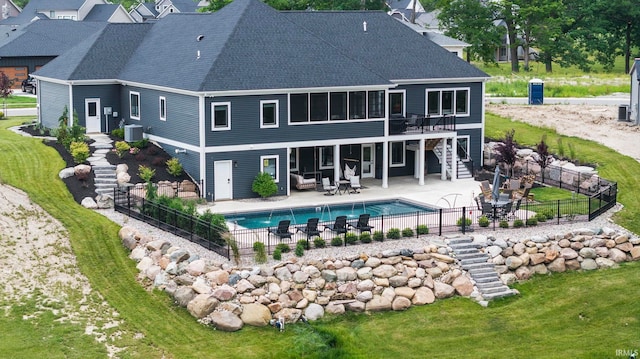 rear view of house with roof with shingles, stairs, a wooden deck, a fenced backyard, and a patio area