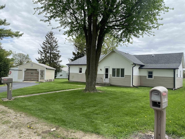 870 W 950 Rd S, Geneva, IN 46740 - view of front of property with driveway, a front yard, a detached garage, an outdoor structure, and a shingled roof