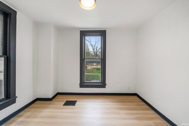 1820 W Main St, Fort Wayne, IN 46808 - empty room featuring baseboards, visible vents, and light wood-type flooring