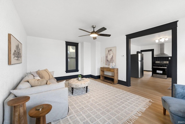 1820 W Main St, Fort Wayne, IN 46808 - living room with baseboards, a ceiling fan, and light wood-style flooring