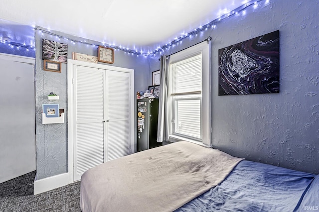bedroom with a closet and a textured wall