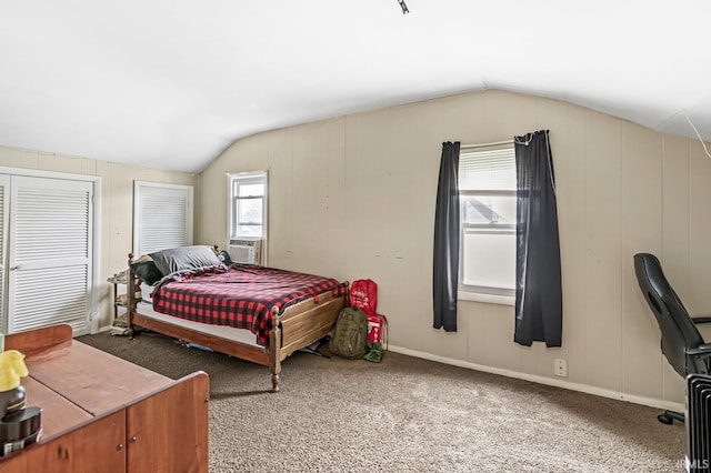 bedroom with carpet floors and lofted ceiling