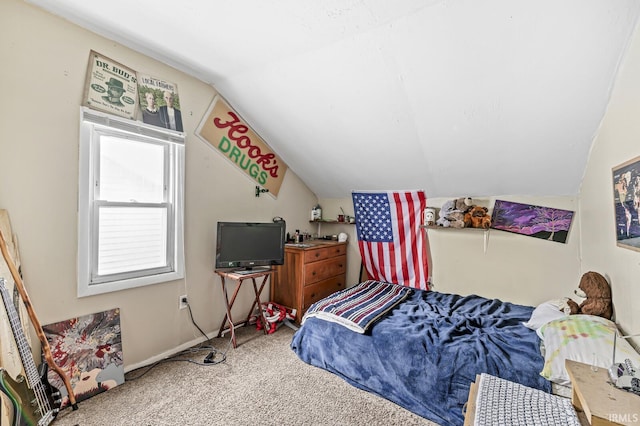 bedroom featuring carpet and vaulted ceiling
