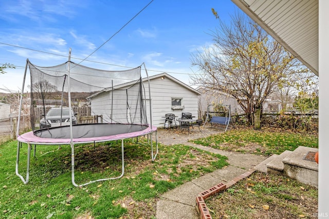 view of yard with a fenced backyard, a trampoline, and a patio area
