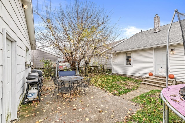 view of yard featuring entry steps, fence, and a patio area