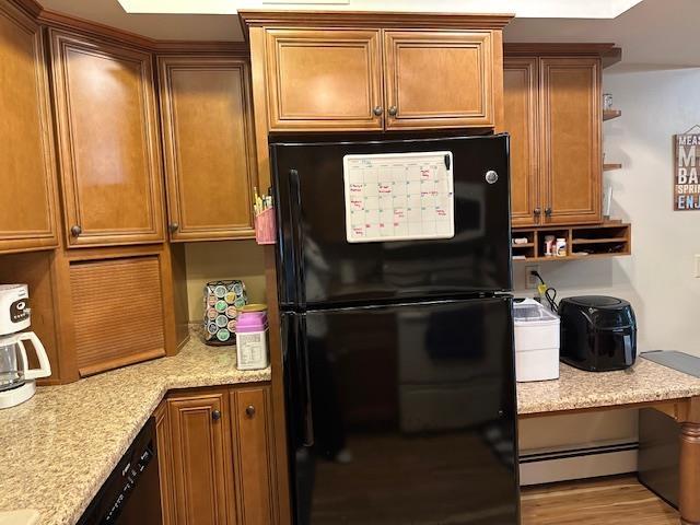 8615 Timbermill Pl, Fort Wayne, IN 46804 - kitchen featuring black appliances, baseboard heating, and brown cabinets