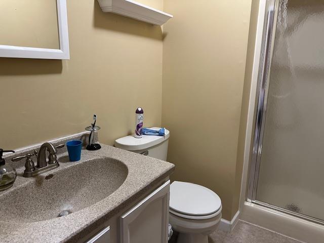 8615 Timbermill Pl, Fort Wayne, IN 46804 - bathroom with toilet, vanity, a stall shower, and tile patterned flooring