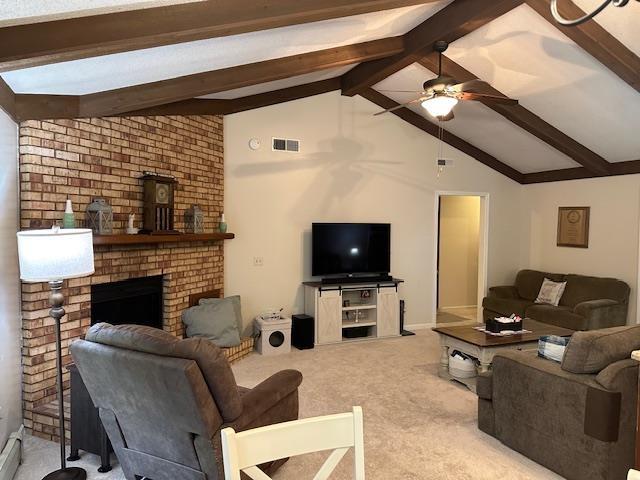 8615 Timbermill Pl, Fort Wayne, IN 46804 - living room featuring ceiling fan, beamed ceiling, carpet floors, a brick fireplace, and high vaulted ceiling