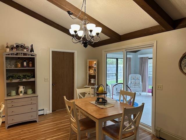 8615 Timbermill Pl, Fort Wayne, IN 46804 - dining space with beam ceiling, wood finished floors, a chandelier, and baseboard heating