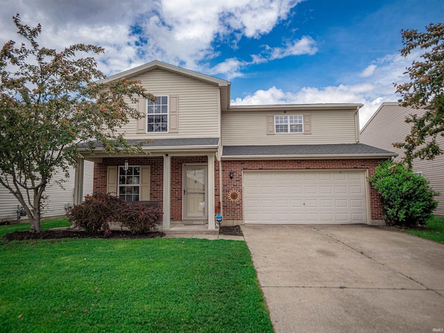 traditional home featuring brick siding, an attached garage, driveway, and a front yard