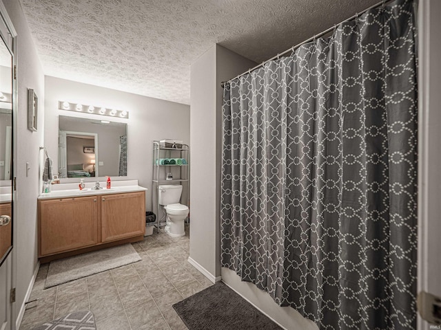full bath with vanity, curtained shower, toilet, and a textured ceiling