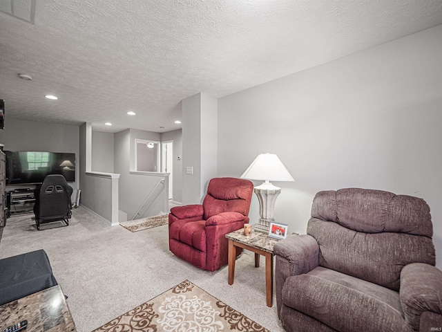 living room with visible vents, light carpet, baseboards, recessed lighting, and a textured ceiling