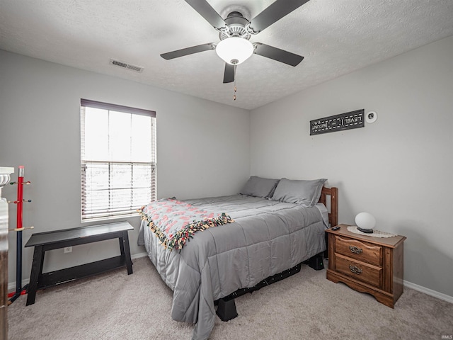 bedroom with carpet, a textured ceiling, and visible vents