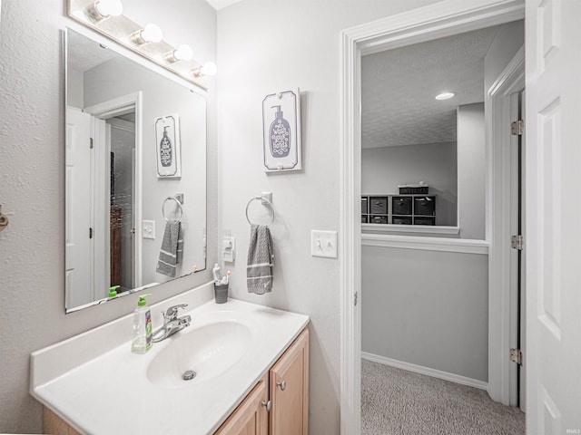 bathroom with a textured ceiling and vanity
