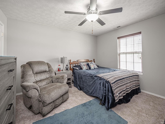 bedroom featuring carpet floors, a ceiling fan, a textured ceiling, and visible vents