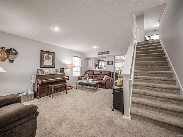 living room with recessed lighting, carpet flooring, a textured ceiling, and stairs