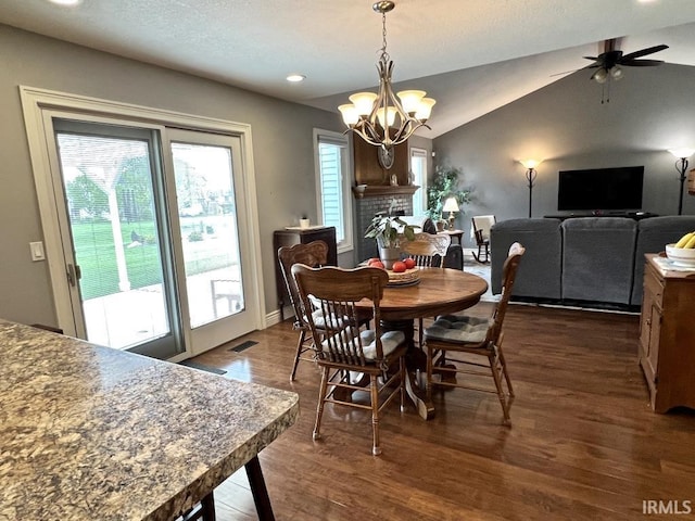 dining space featuring visible vents, ceiling fan with notable chandelier, dark wood-style floors, lofted ceiling, and recessed lighting