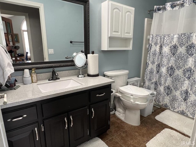 full bathroom featuring tile patterned floors, vanity, toilet, and curtained shower