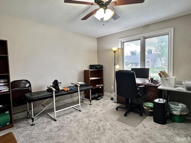 office area featuring baseboards, a ceiling fan, carpet, and a textured ceiling