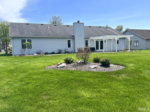 back of property with a pergola, a chimney, a yard, and a patio area