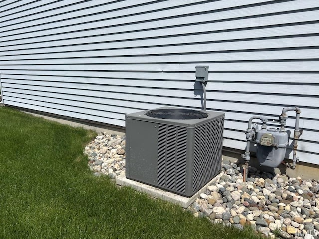 exterior details featuring central AC unit and gas meter