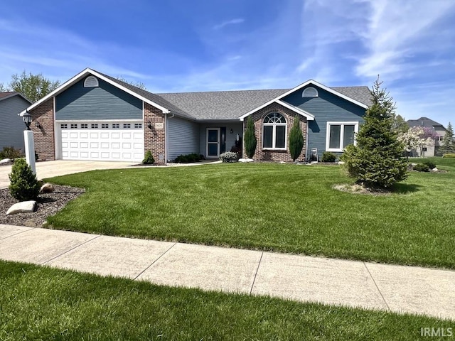 view of front of home with brick siding, a front yard, and a garage