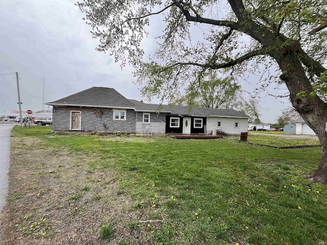 view of front of home featuring a shingled roof, a wooden deck, stone siding, and a front yard