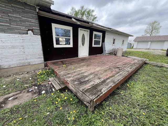 wooden terrace featuring a lawn