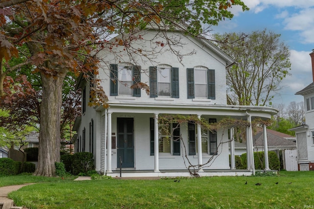 113 W N Shore Dr, South Bend, IN 46617 - italianate house featuring a front yard, a porch, and brick siding