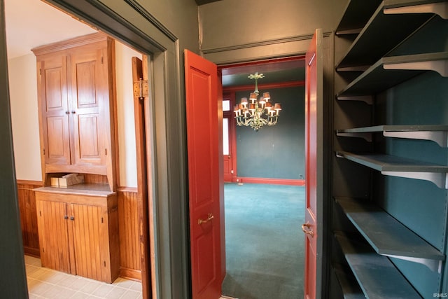 113 W N Shore Dr, South Bend, IN 46617 - hall featuring wainscoting, light colored carpet, and a chandelier