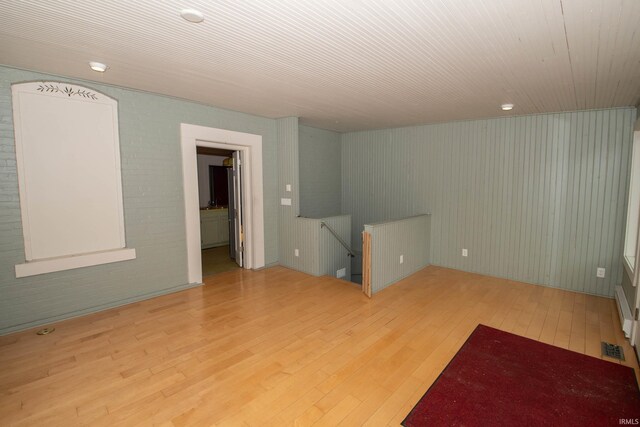 113 W N Shore Dr, South Bend, IN 46617 - spare room featuring wood-type flooring, brick wall, and visible vents
